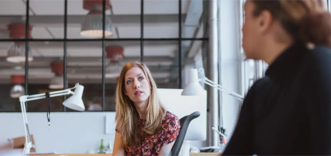 a woman talking to a man