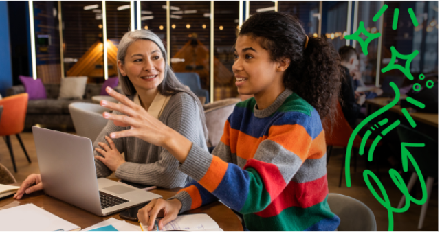 two women looking at a laptop