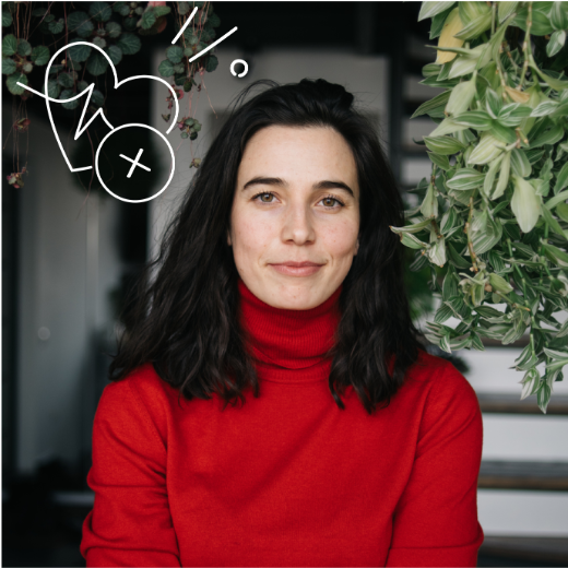Woman in a red turtleneck, with a white illustrated heart and plus symbol graphic above her left shoulder.