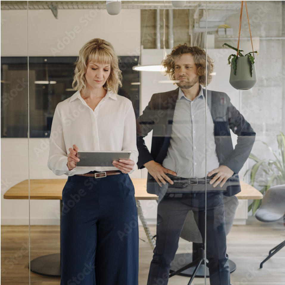 a man and a woman holding a laptop