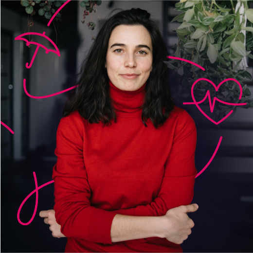 a man smiling while holding a pen